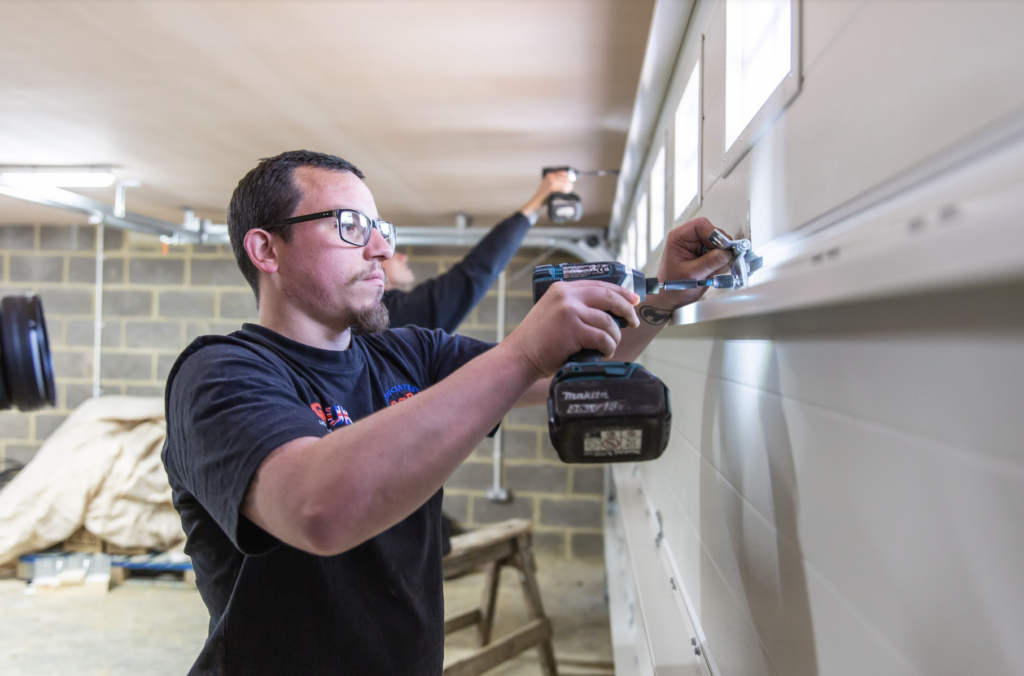 JB Garage Doors team member fitting a new double garage door